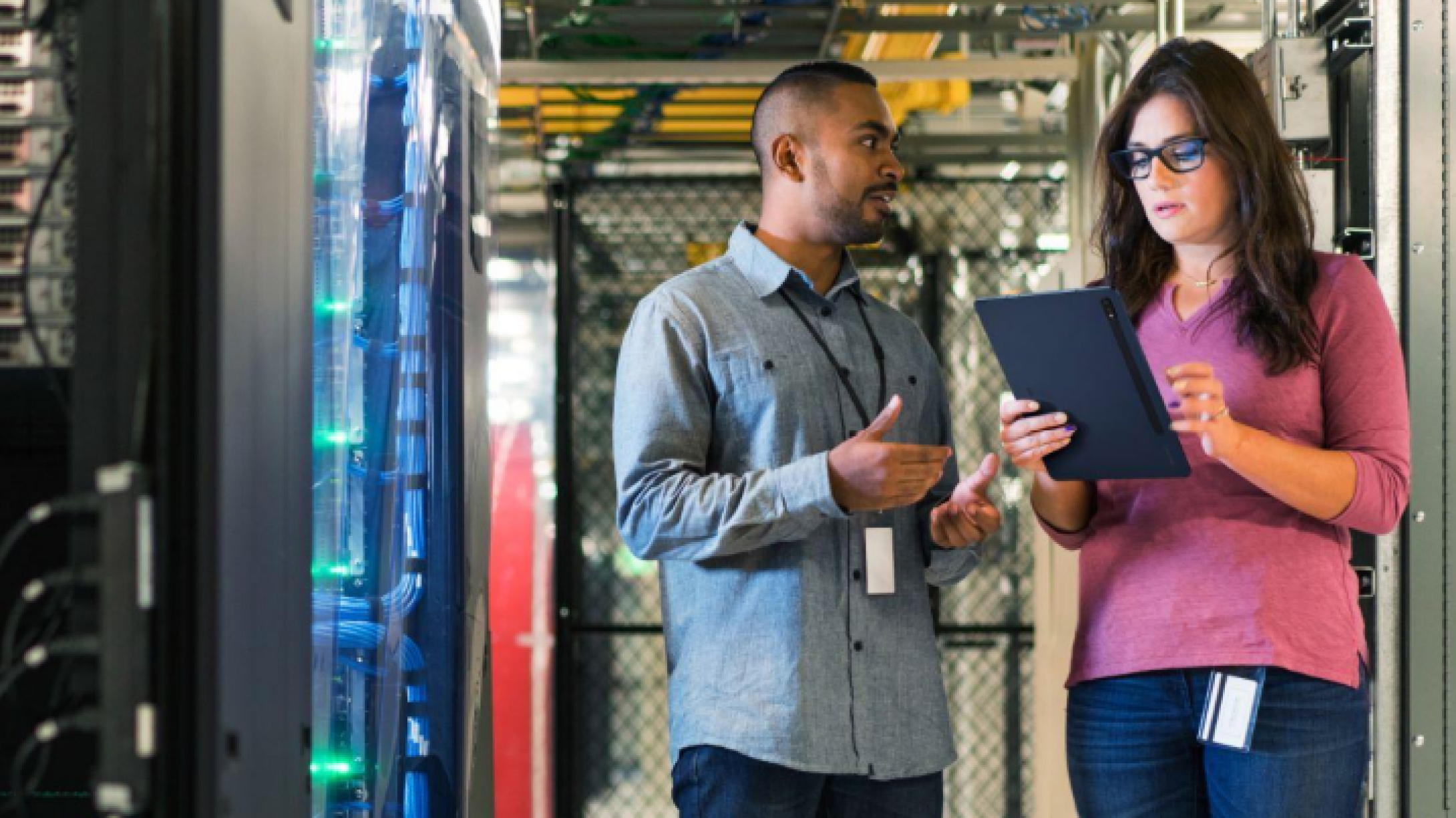 A man and a woman conducting a data center inspection
