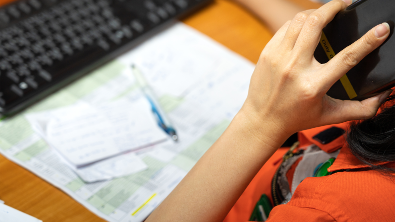 emergency responder reviewing computer and map while on the phone