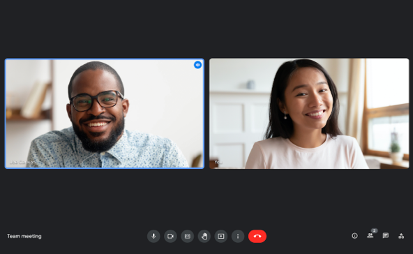 two people on a video call smiling on camera